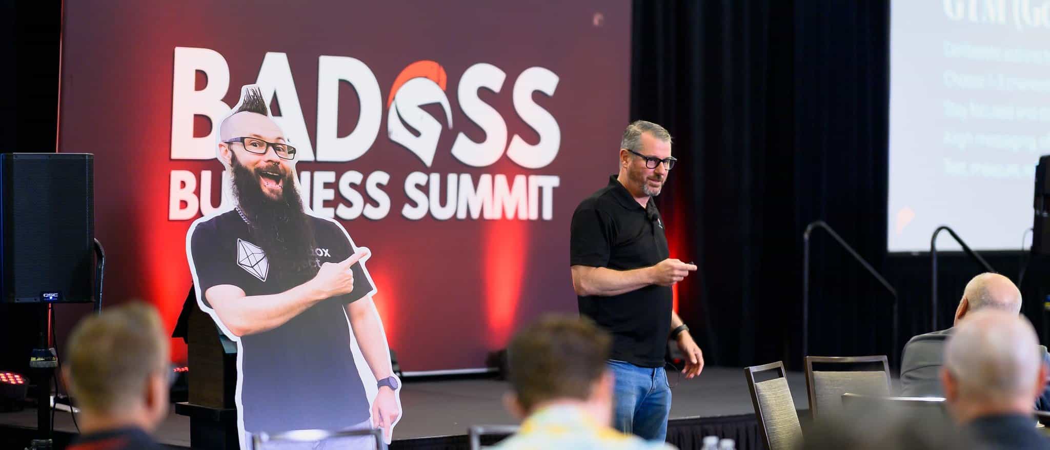 Jerry Macnamara speaking on stage at the Badass Business Summit