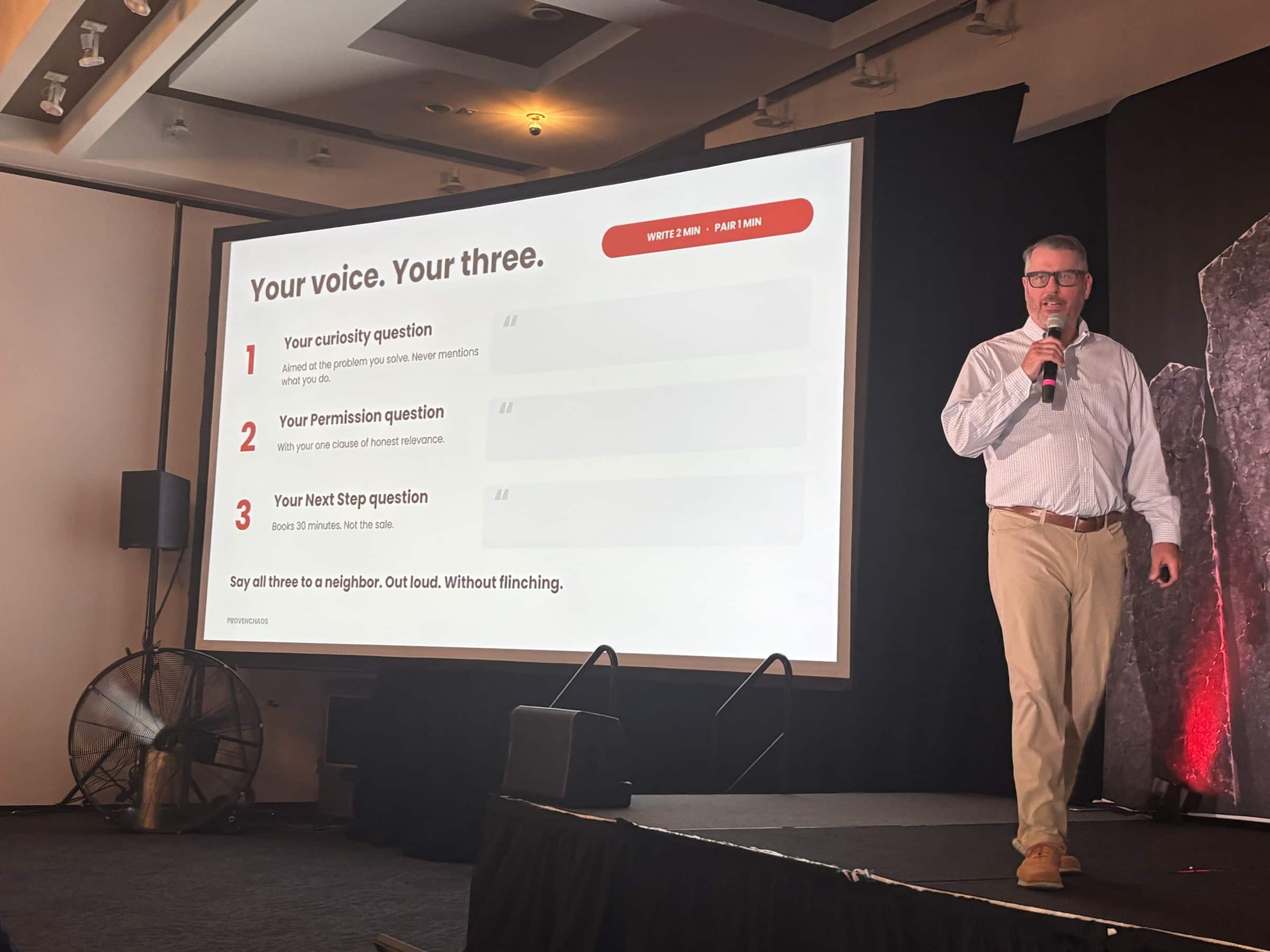 Jerry Macnamara beside the exercise slide at the Badass Business Summit 2026, working the room